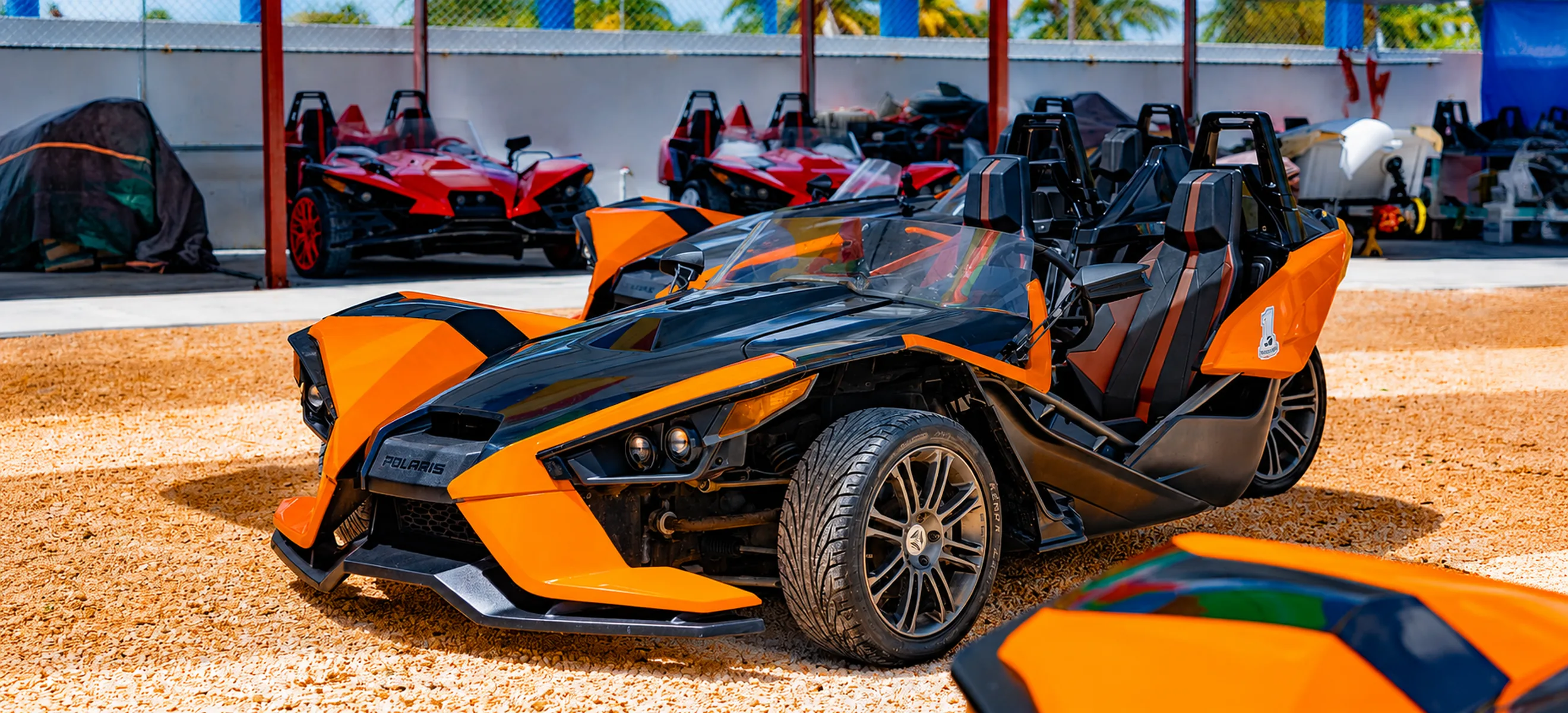 Orange and black Polaris Slingshot parked at the Macao Slingshot HUB before a guided tour through Nisibón and Macao Beach in Punta Cana.