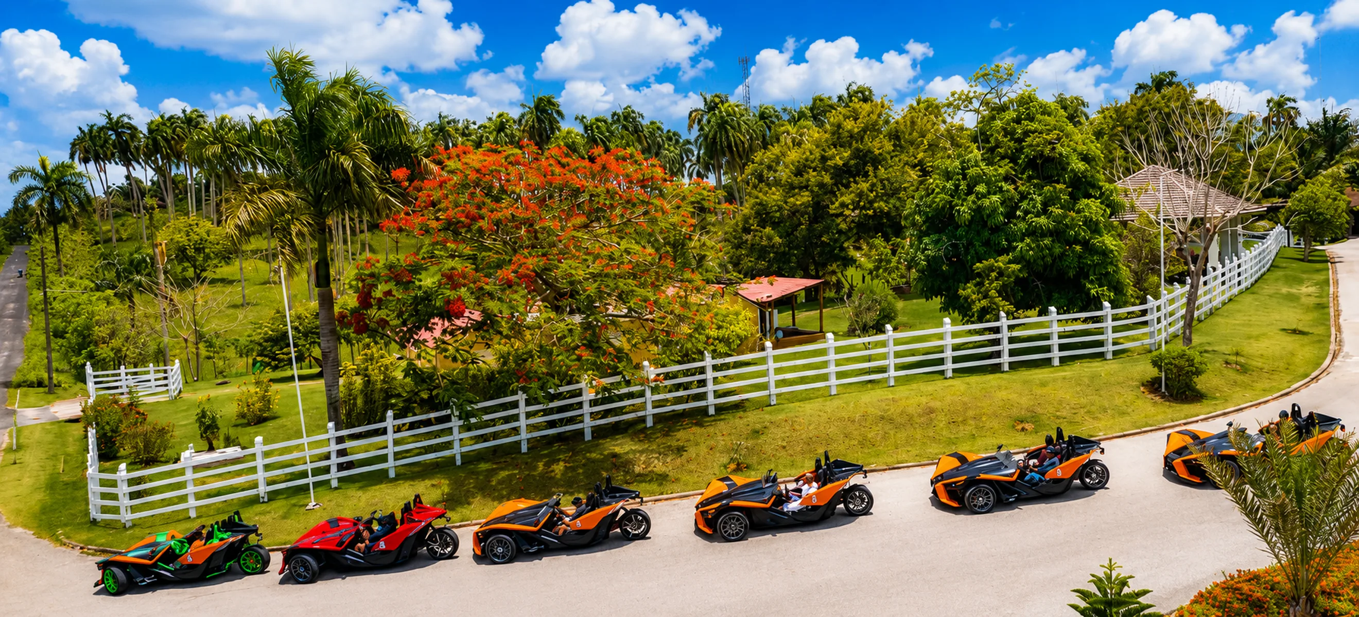 Aerial view of a Polaris Slingshot convoy driving past a beautiful tropical country estate during a guided Punta Cana Slingshot adventure in the Dominican Republic. 