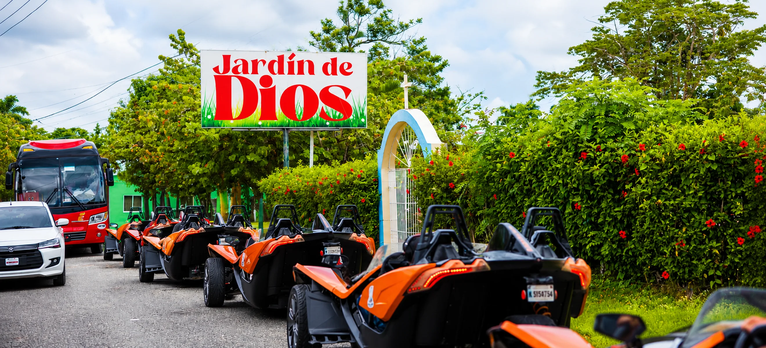 	Convoy of Polaris Slingshot vehicles passing the Jardín de Dios landmark during a guided Slingshot tour through the scenic Nisibón countryside in Punta Cana.