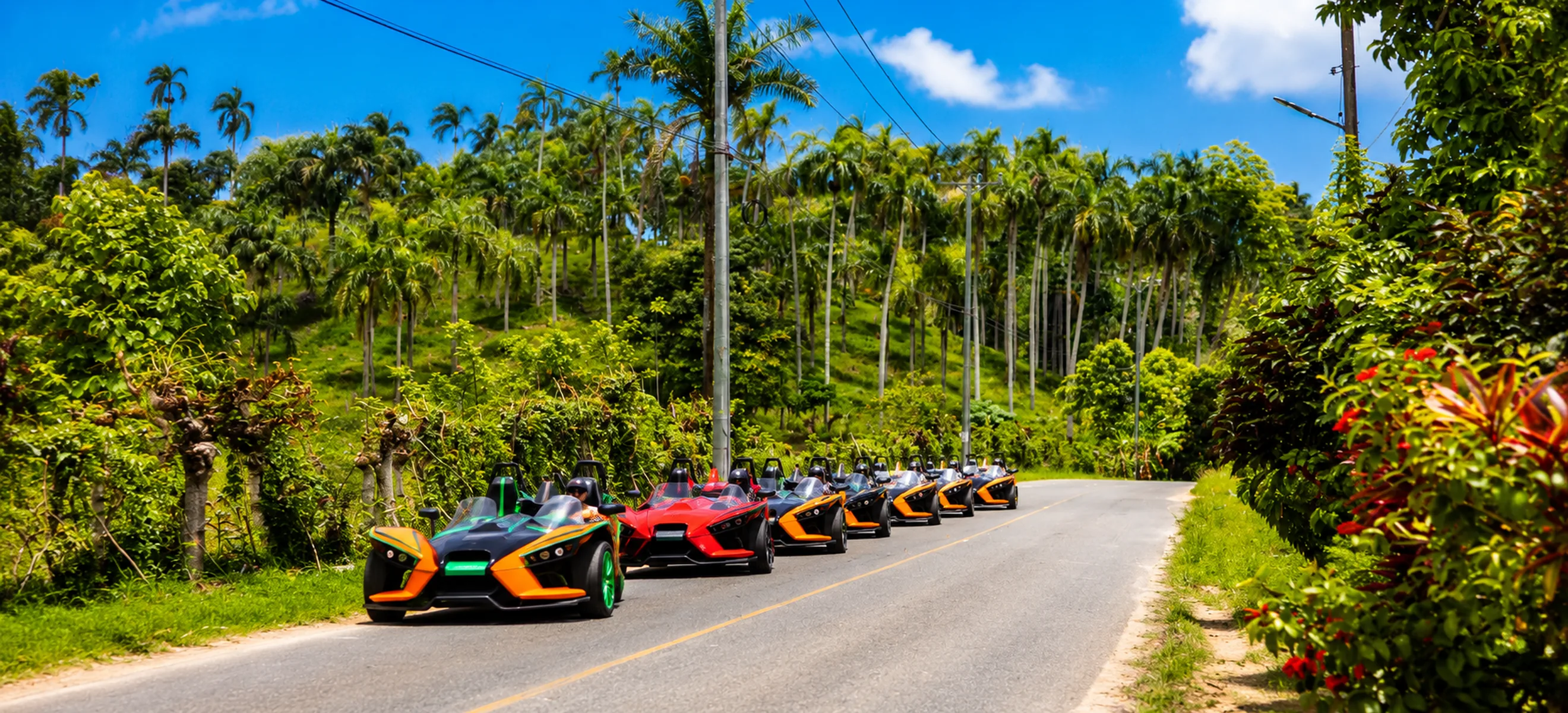 Convoy of Polaris Slingshot vehicles driving through the scenic palm-lined roads of Nisibón during a guided Punta Cana Slingshot adventure.