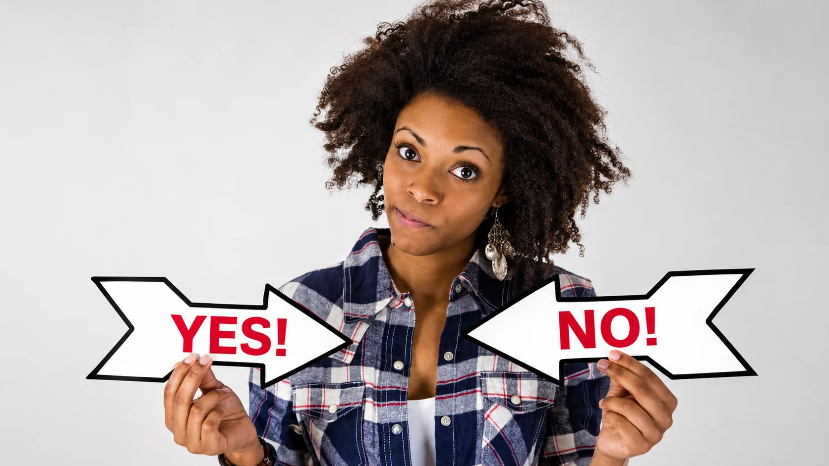 black girl with the arrow sing on each of her hands pointing to opposite directions