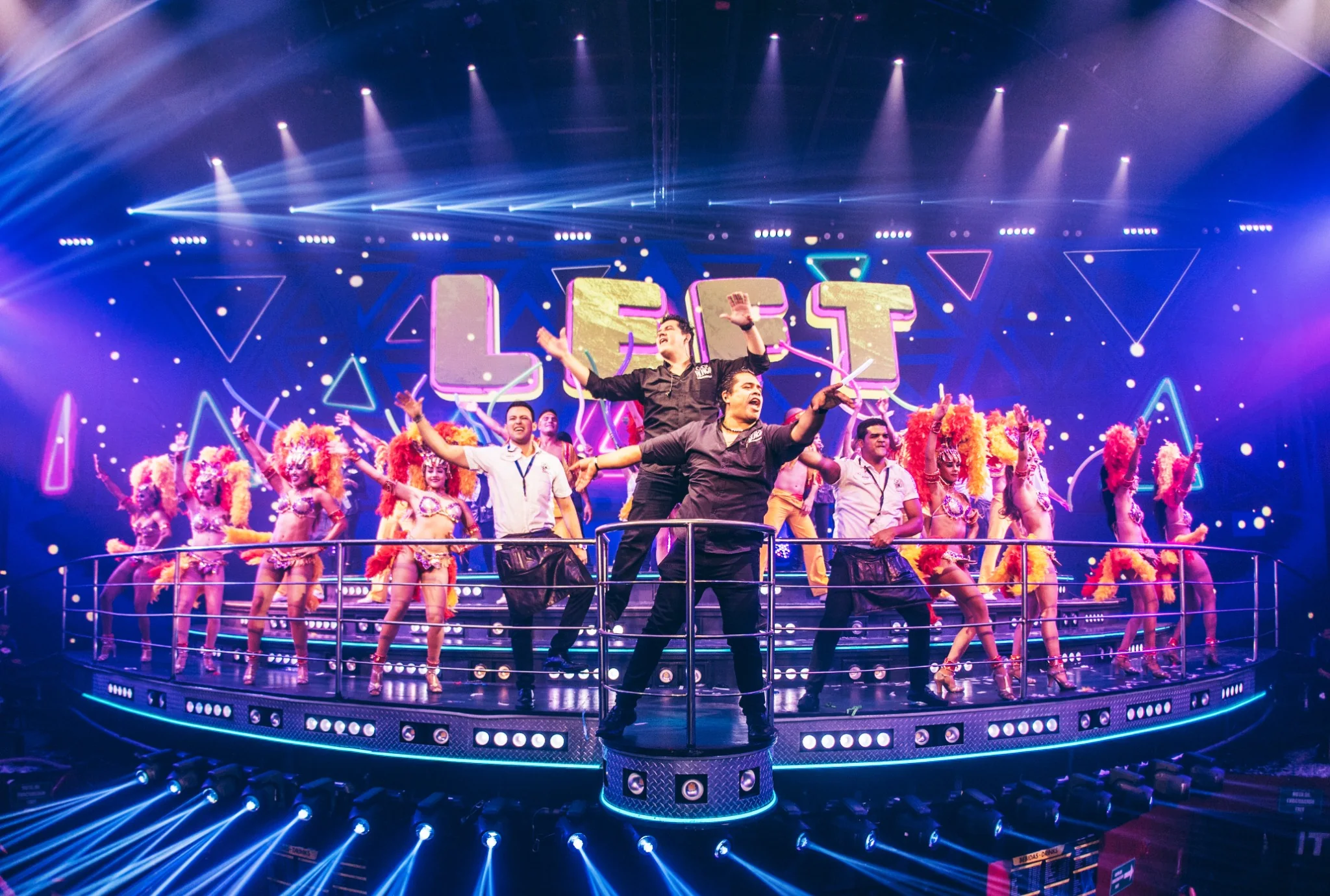 Large dance production on illuminated stage at Coco Bongo Punta Cana