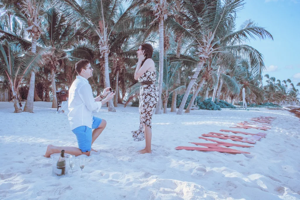 Couple celebrating a romantic beach proposal in Punta Cana with Will You Marry Me letters