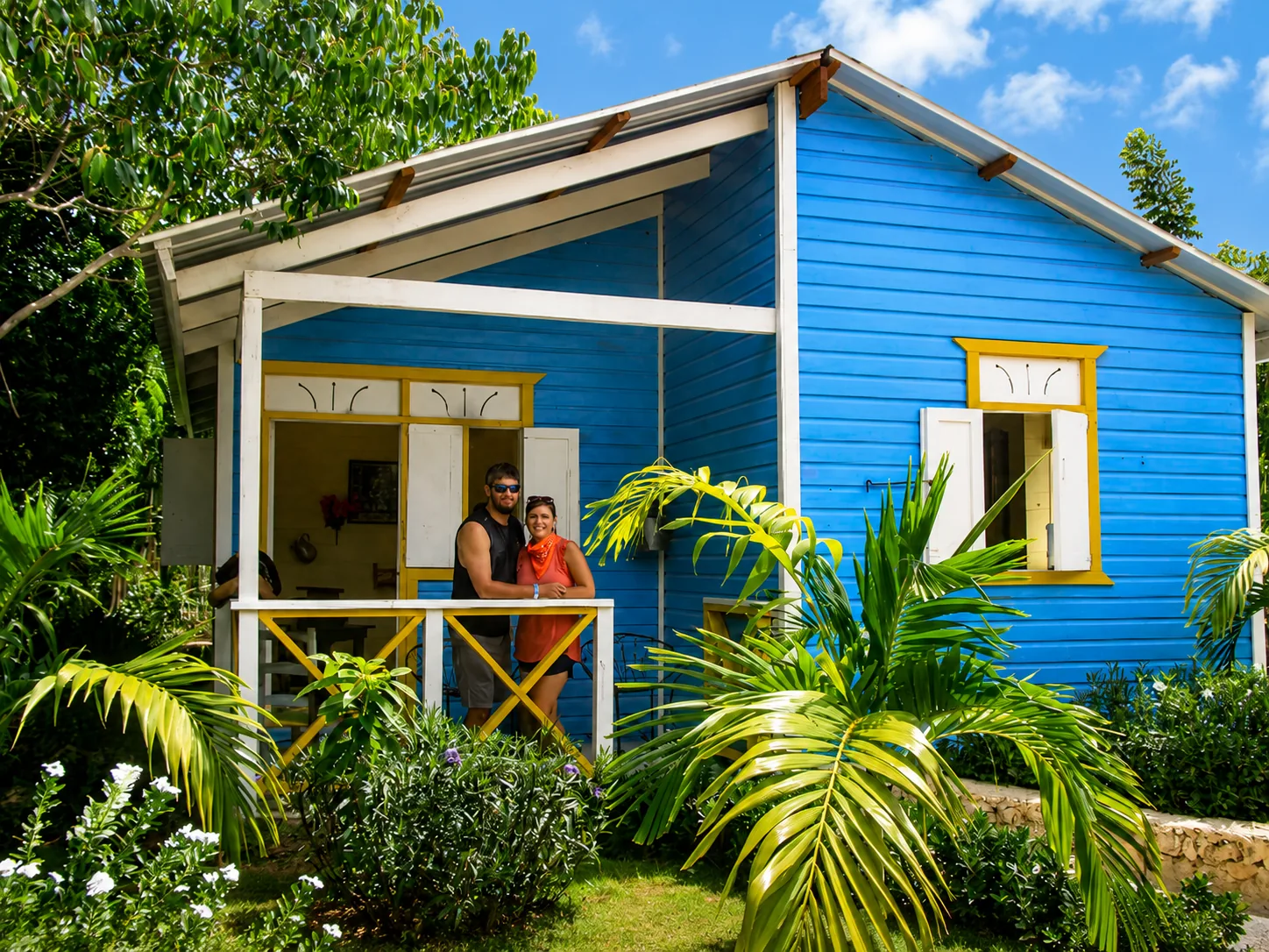 Colorful traditional blue house surrounded by tropical gardens at bavaro adventure  Punta Cana