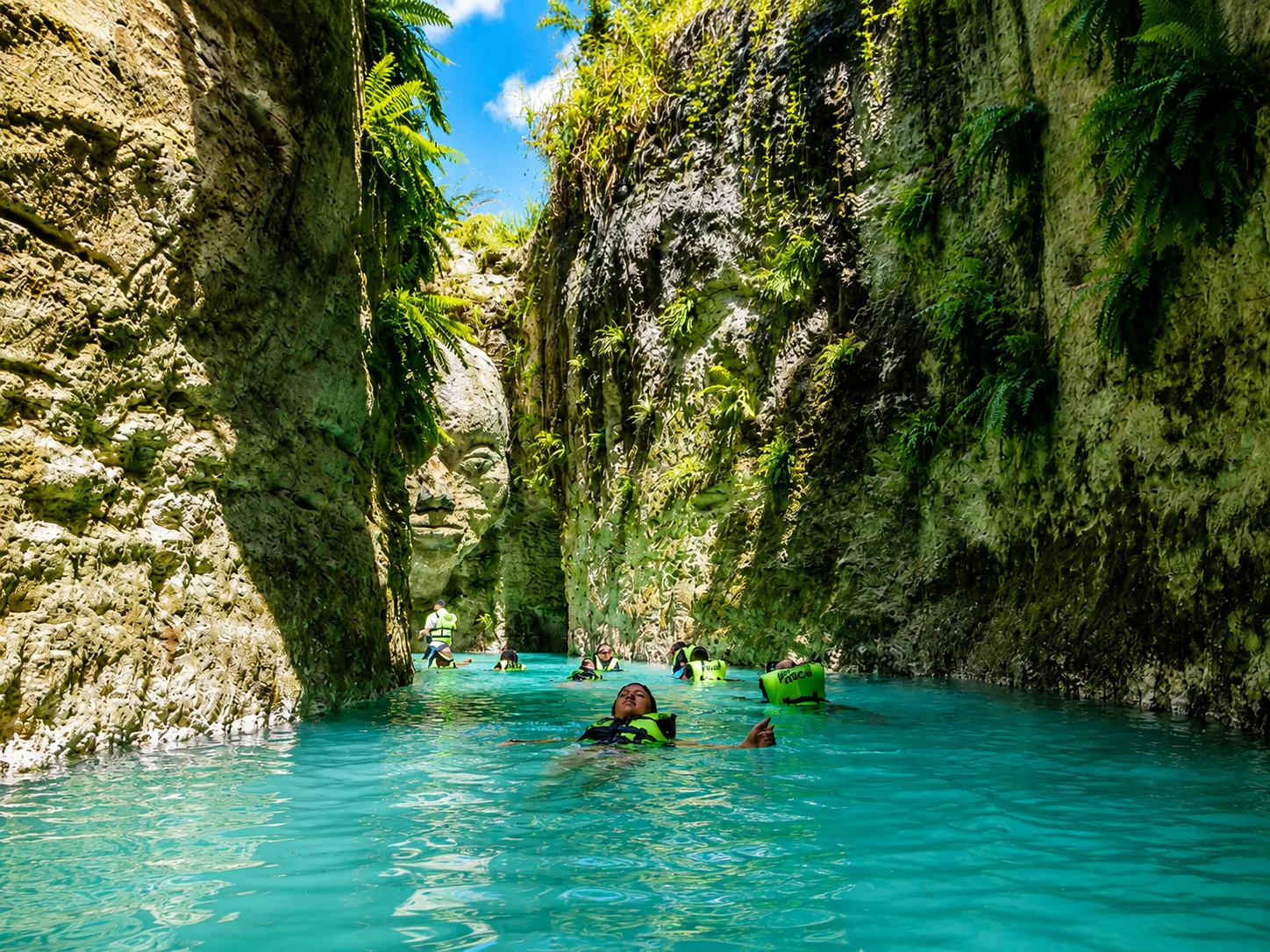 Guests swimming throGuests swimming through turquoise canyon waters at Scape Park Punta Canaugh turquoise canyon waters at bavaro adventure Punta Cana