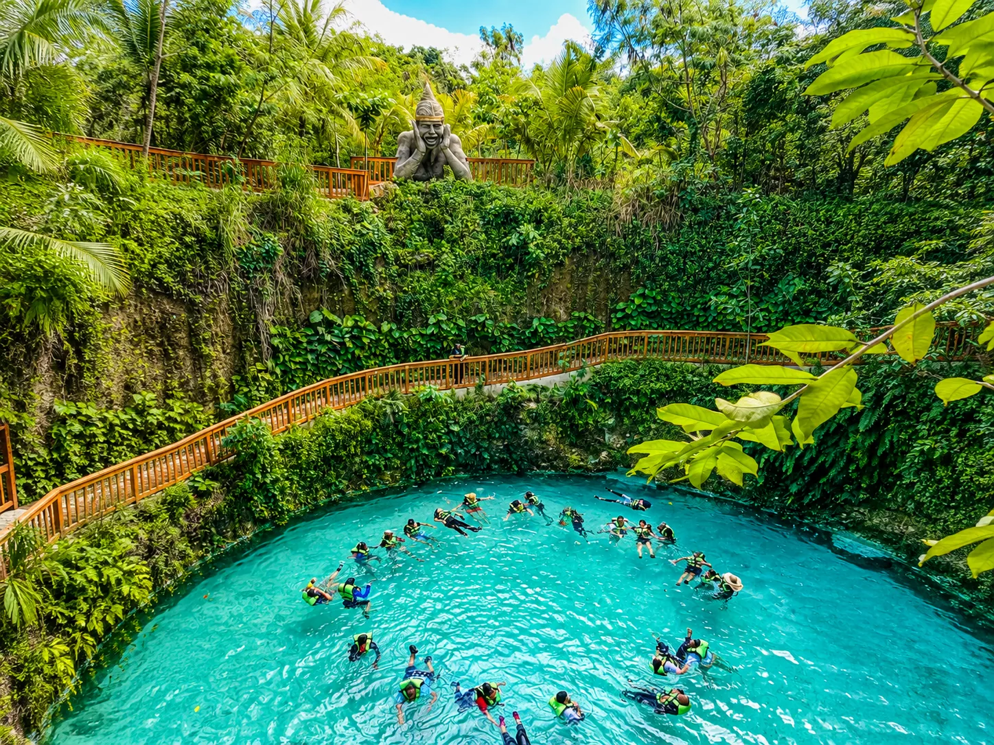 Guests swimming in turquoise Sacred Cenote at bavaro adventure park