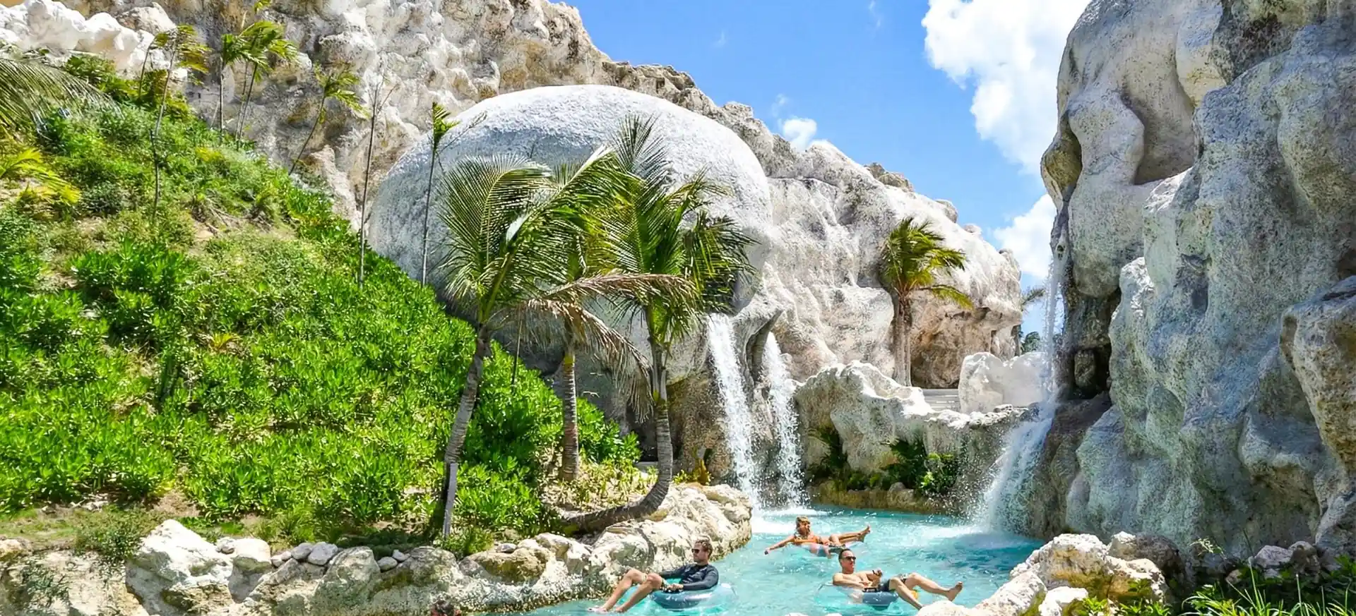 Guests floating through the lazy river and waterfalls at El Dorado Park Punta Cana.