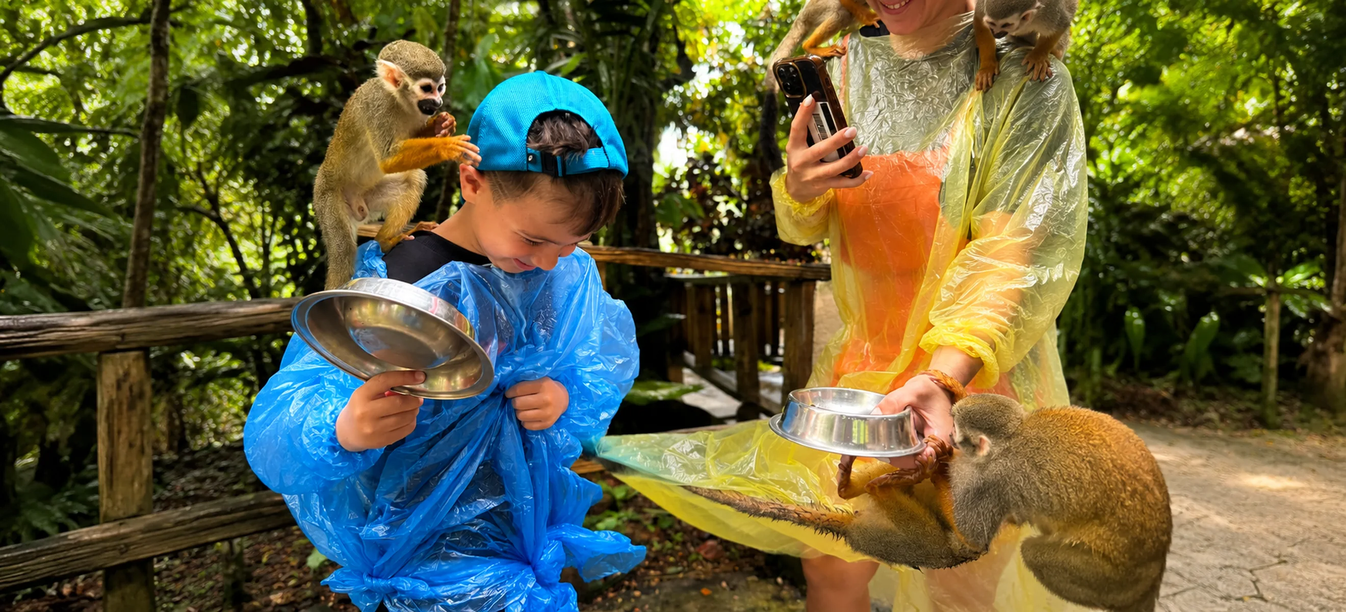 Family enjoying squirrel monkey interaction at Monkeyland Punta Cana