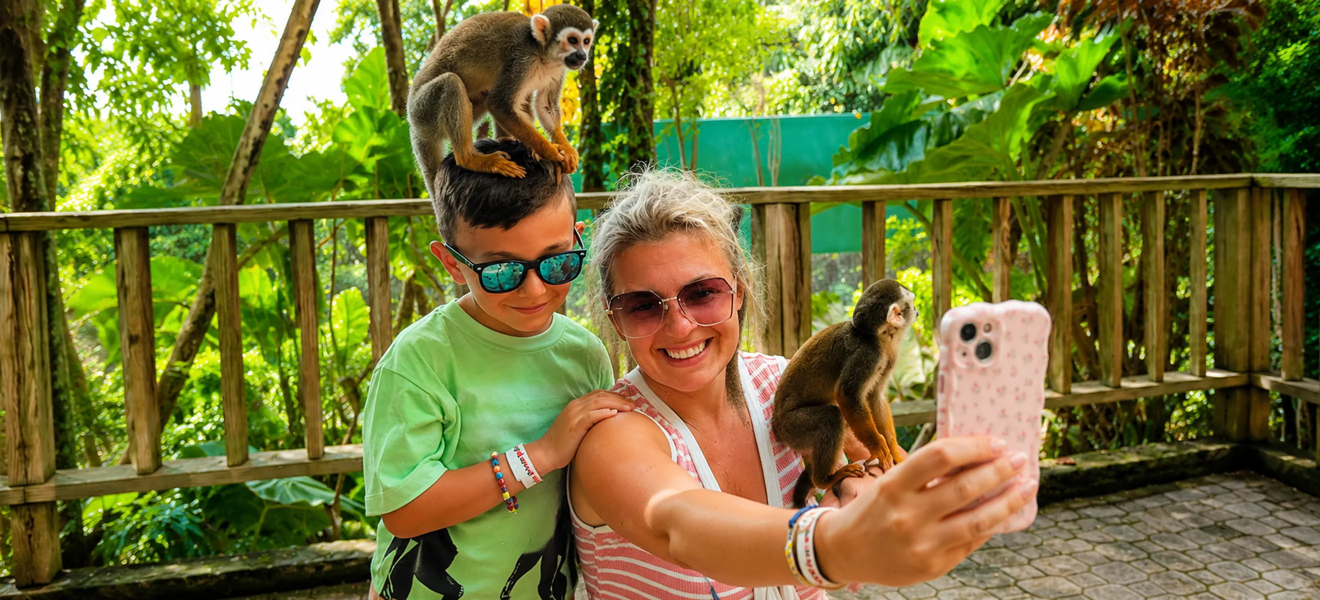 Family taking selfie with squirrel monkeys at Monkeyland Punta Cana