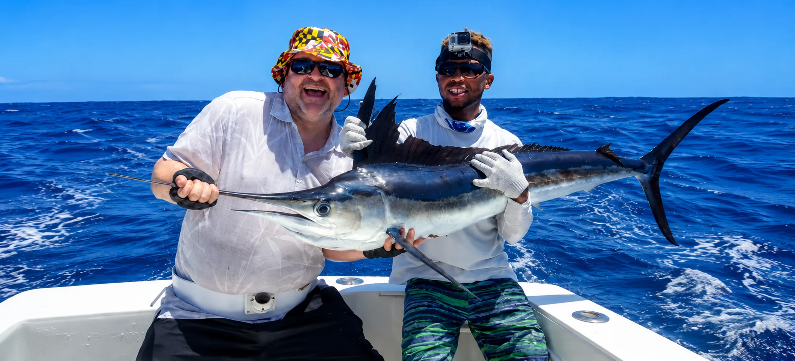 Deep sea fishing guests holding large marlin offshore in Punta Cana