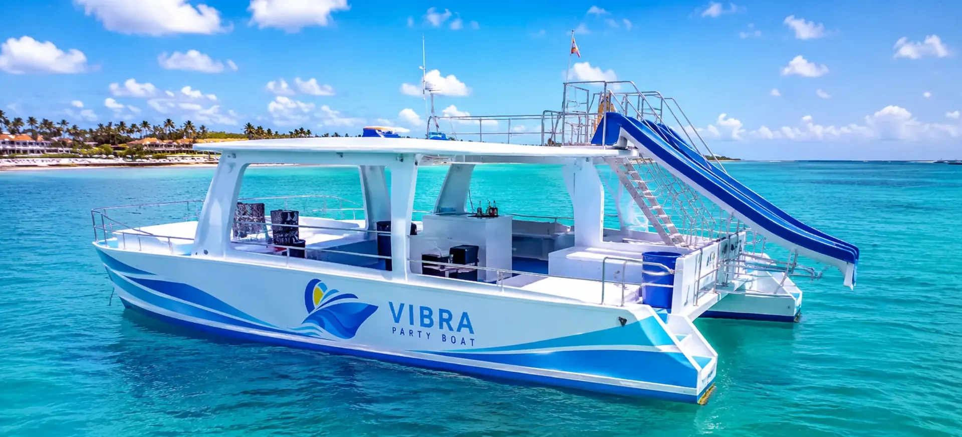 ibra Party Boat catamaran floating in turquoise water in Punta Cana