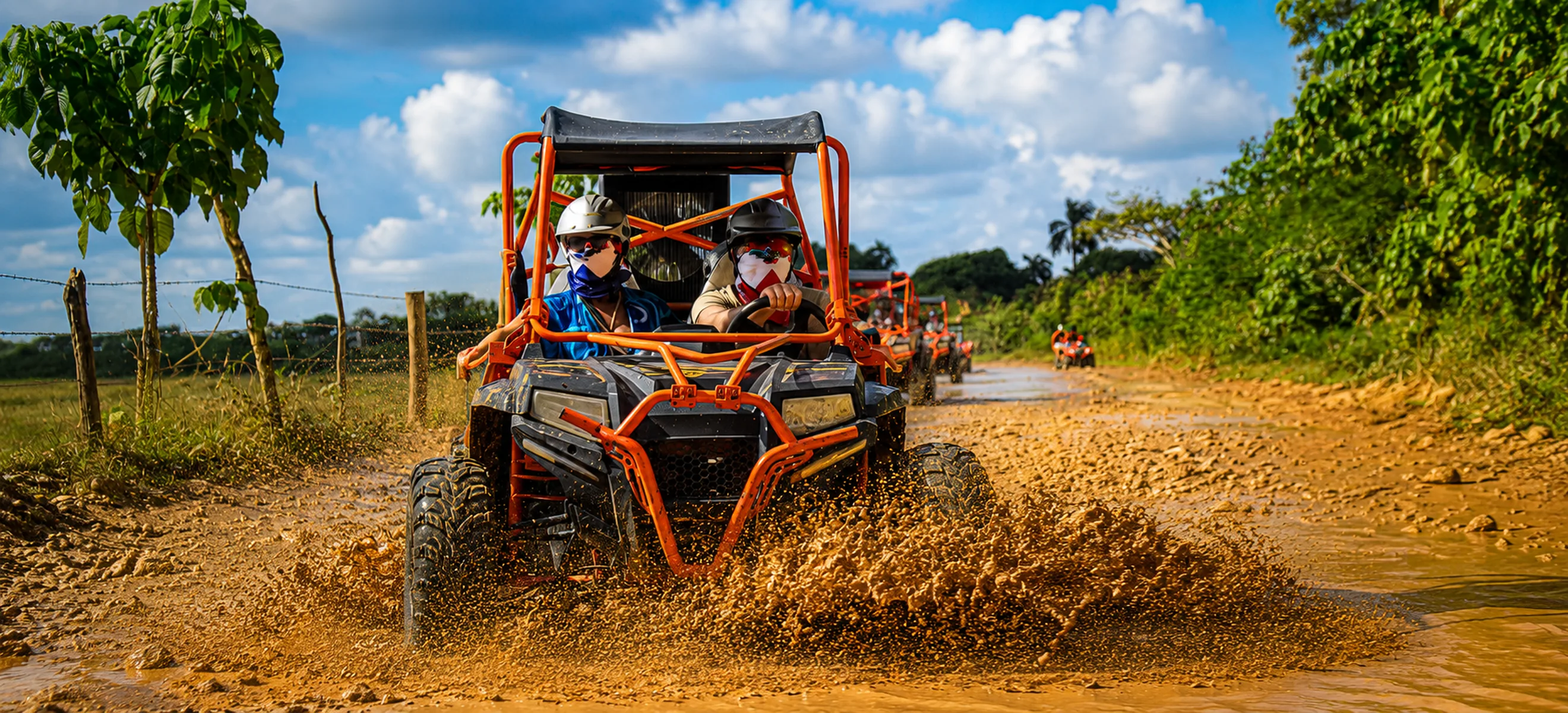 Family riding UTV through muddy trail during Wild Trails Buggies excursion in Punta Cana