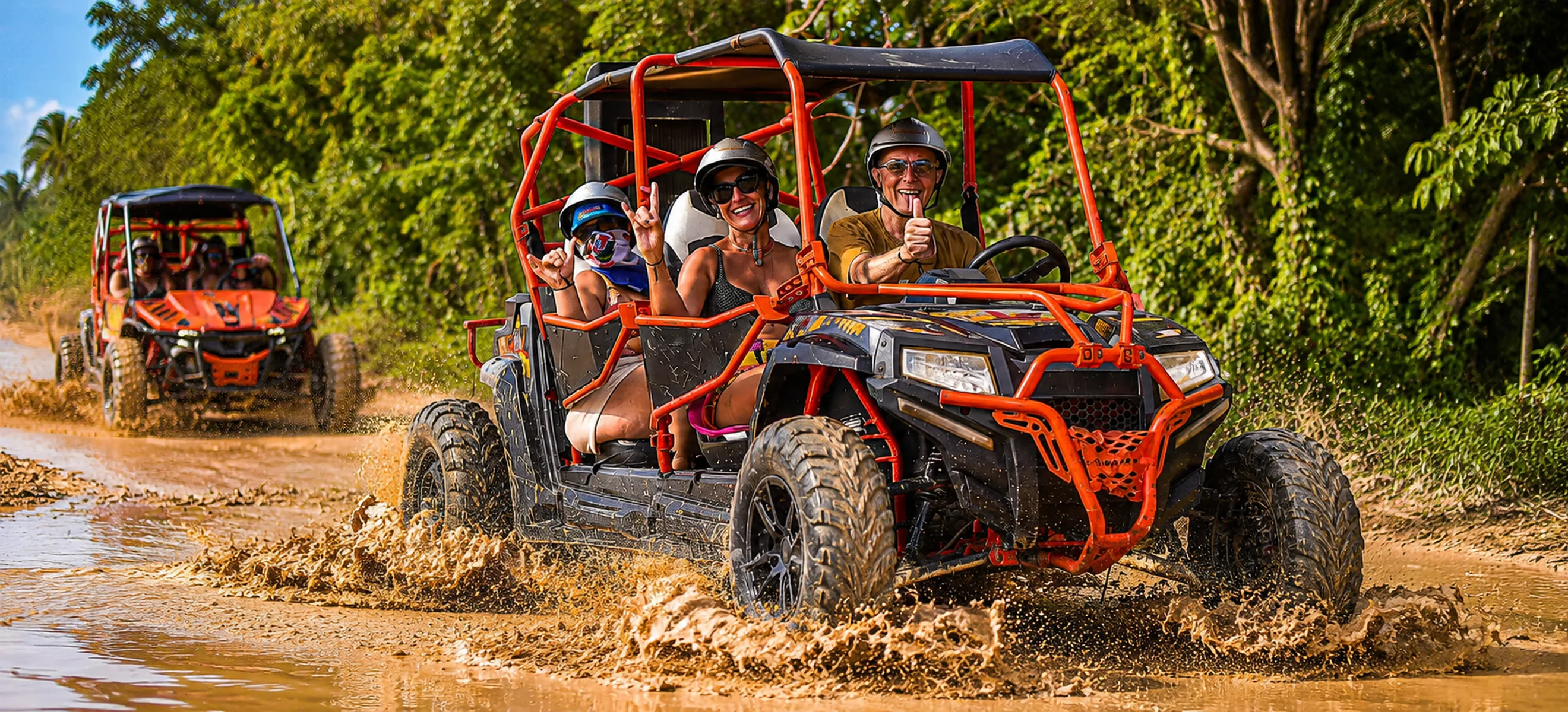 Wild Trails buggy convoy splashing through muddy off-road trail in Punta Cana