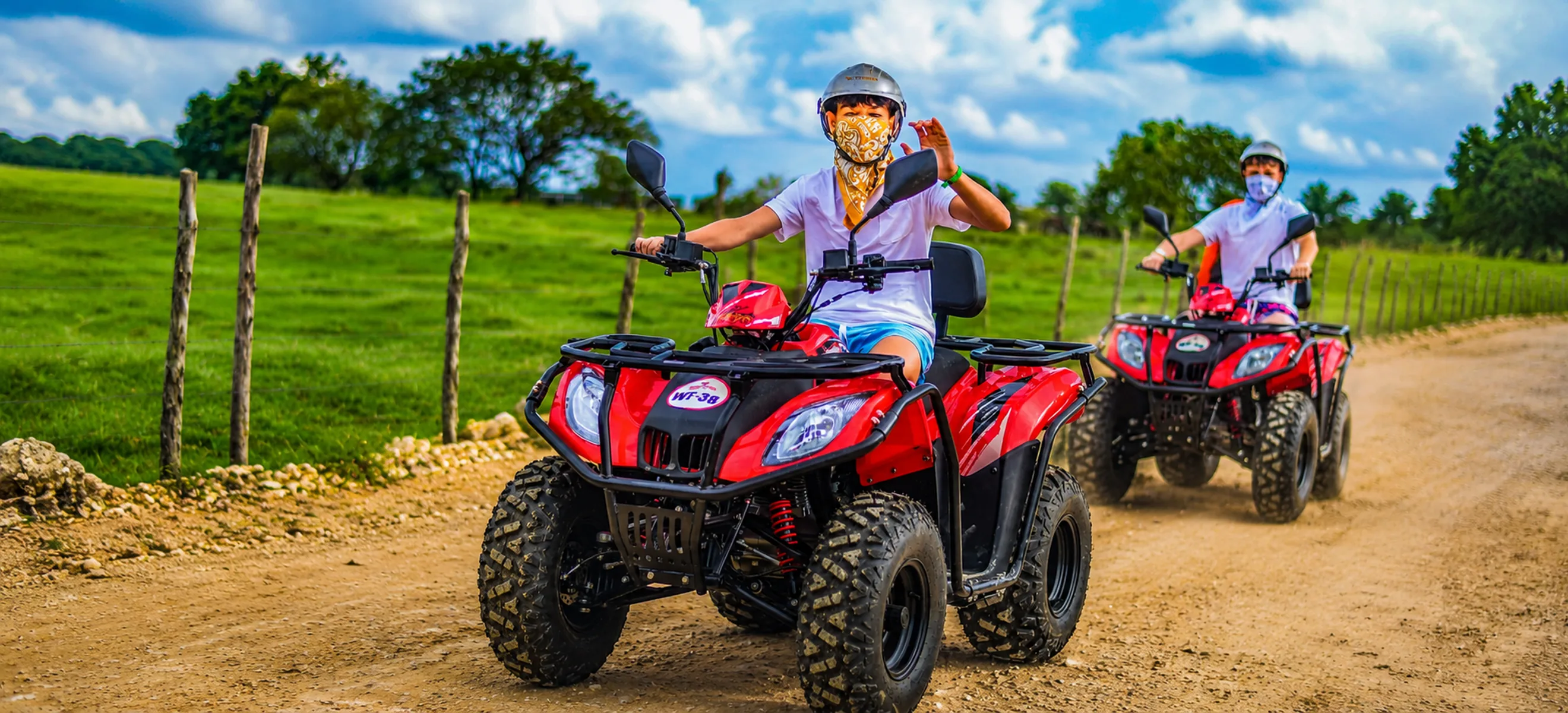 ATV riders splashing through muddy trail on Wild Trails adventure in Punta Cana