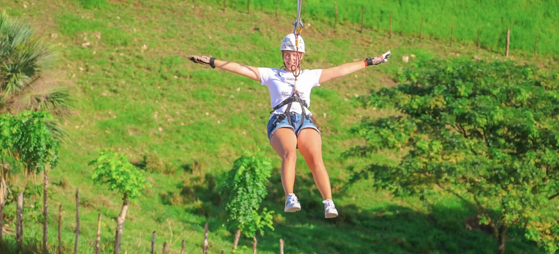 uest riding a zipline over the countryside in Punta Cana