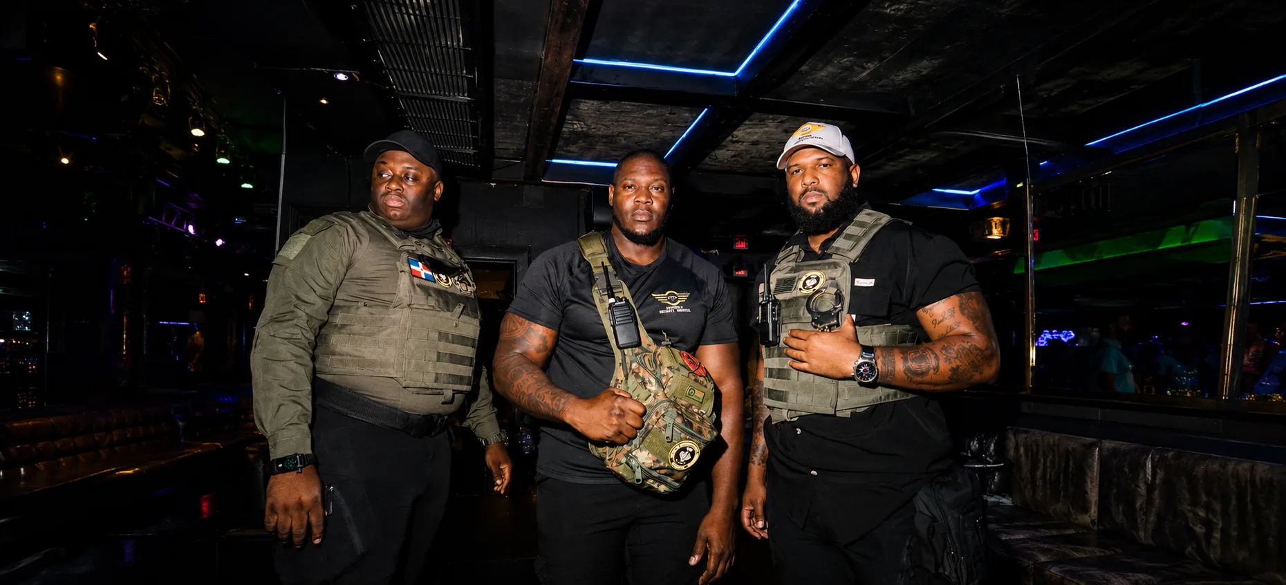 hree nightclub security team members standing inside a VIP lounge