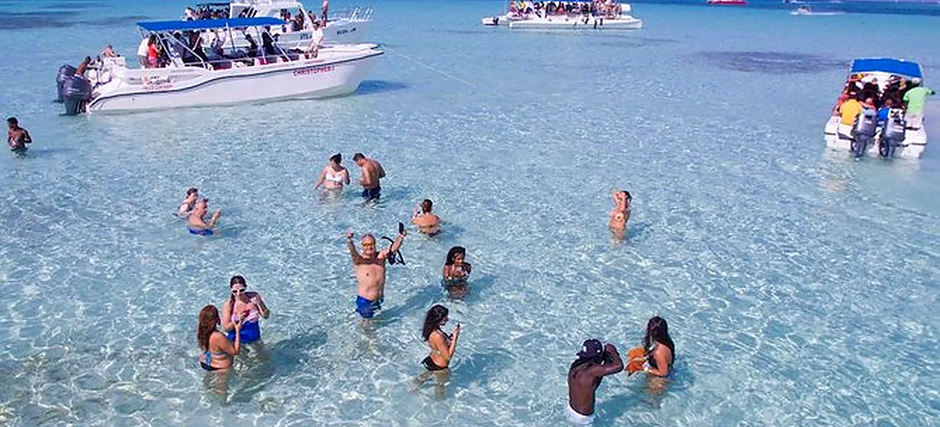 Saona Island natural pool with visitors swimming in shallow crystal-clear water