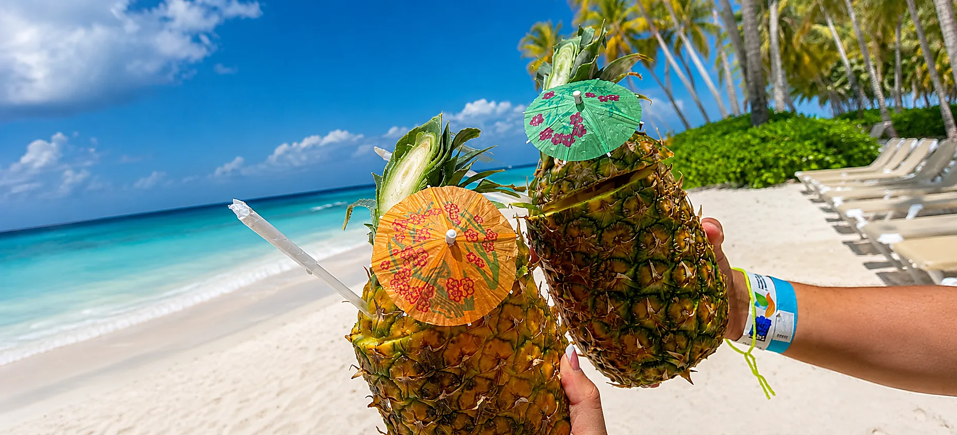Pineapple drinks on Saona Island beach with turquoise water and palm trees