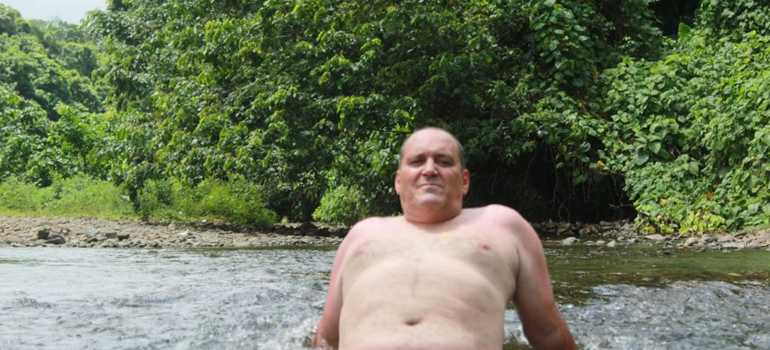 Guest relaxing in a tropical river during a stop on a Punta Cana ATV excursion.