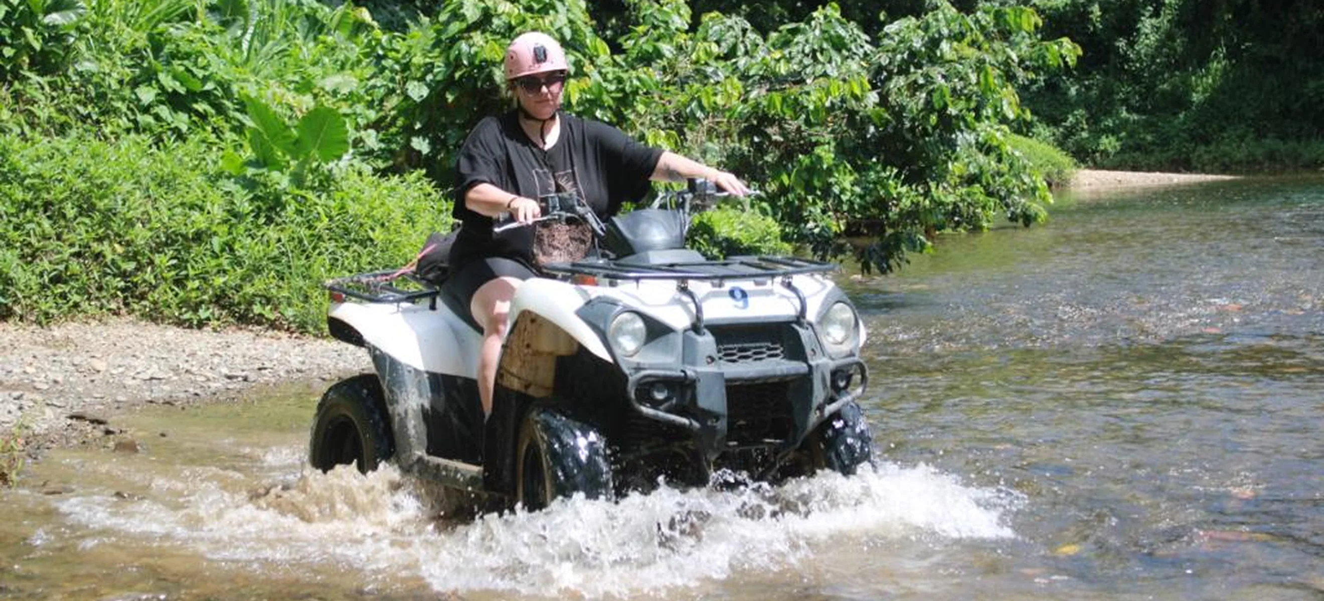 ATV riders traveling through a muddy countryside trail on a Punta Cana adventure.