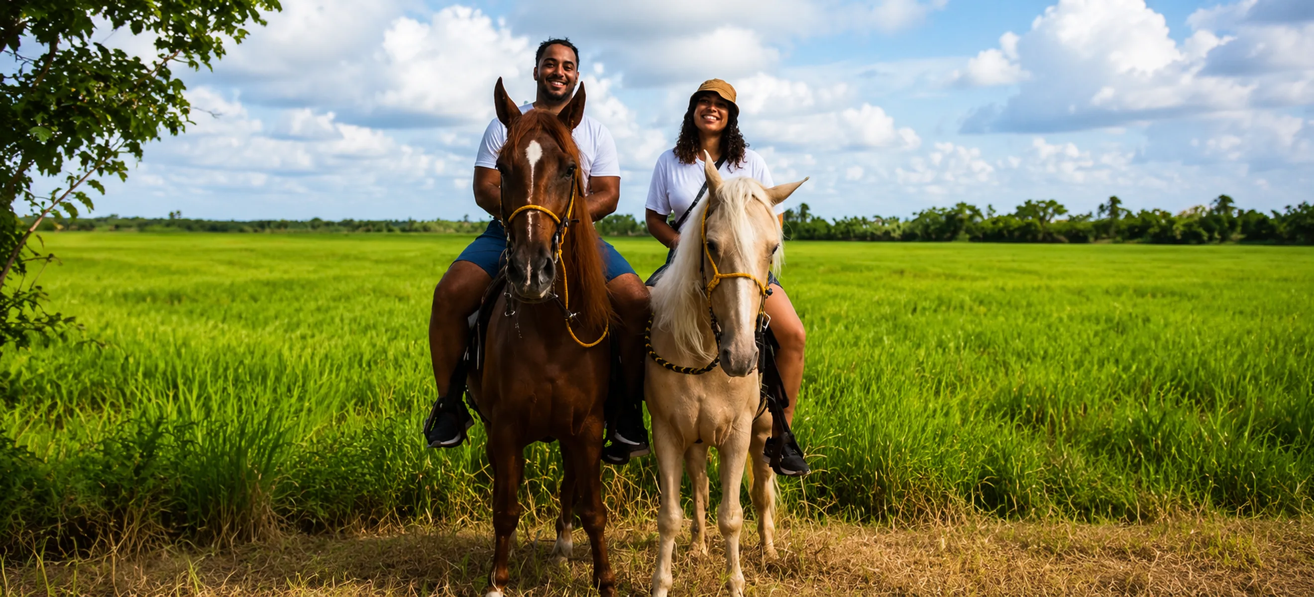 Couple horseback riding through the tropical countryside of Punta Cana Dominican Republic