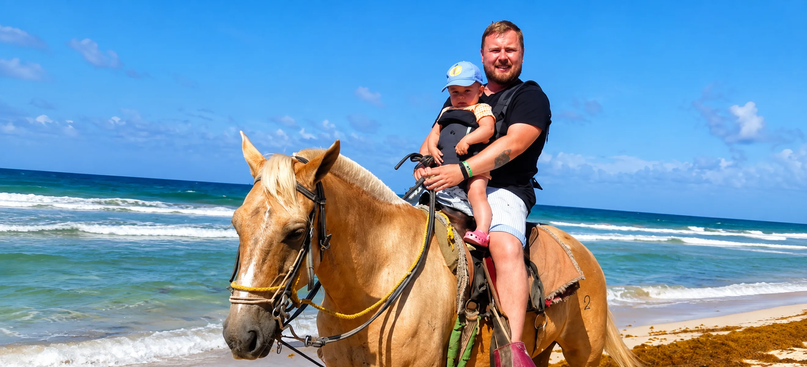 Family enjoying beach horseback riding in Punta Cana beside the Caribbean Sea