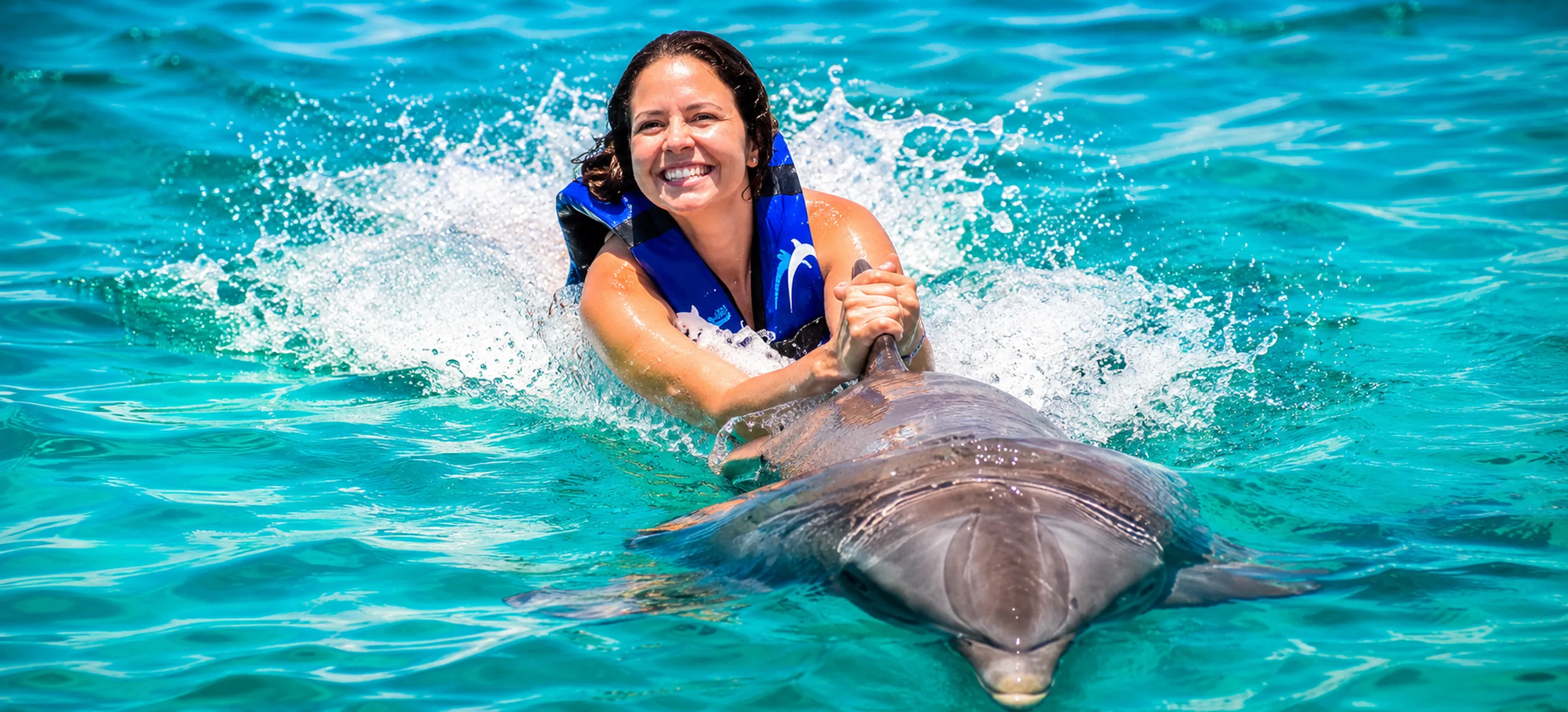 Guest enjoying a dolphin belly ride experience in Punta Cana