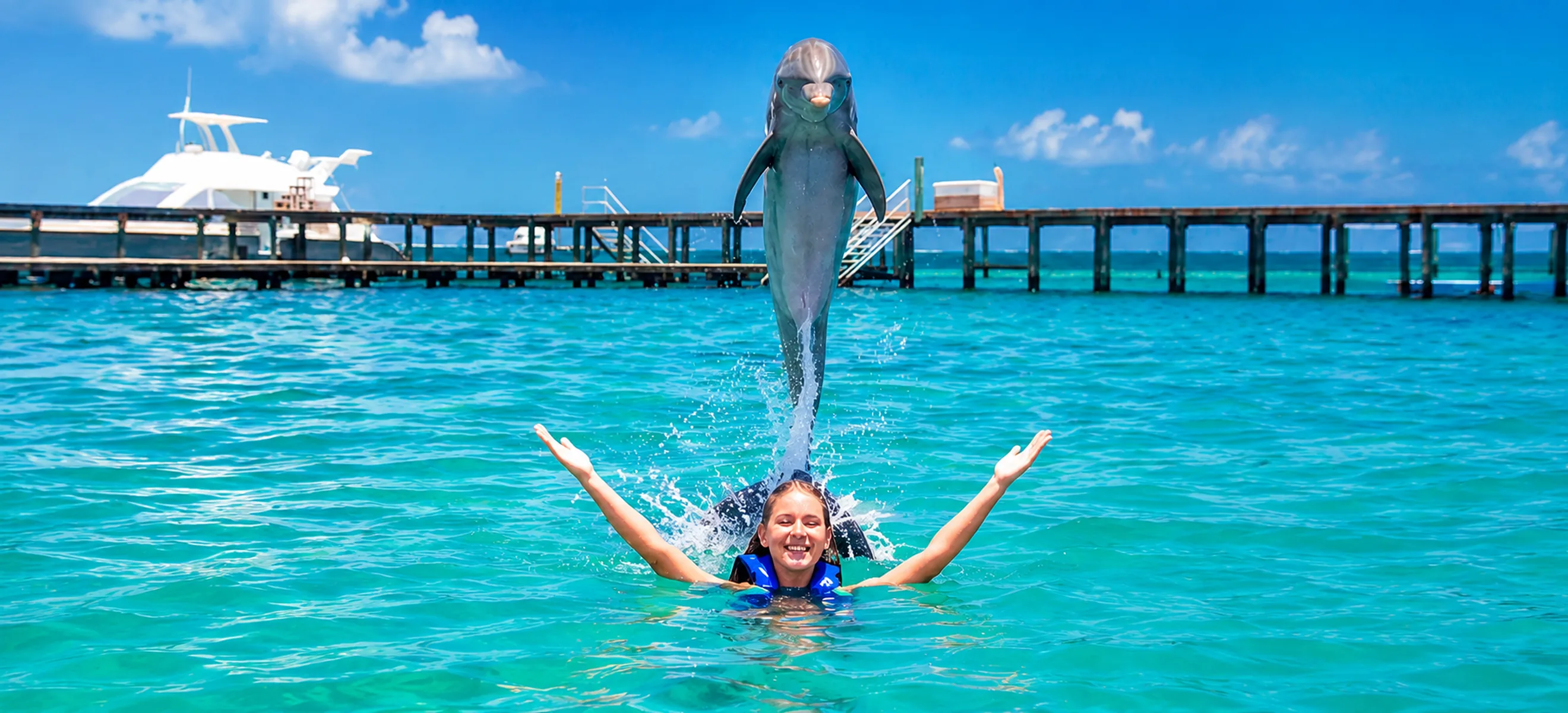 Guest swimming with a jumping dolphin at Dolphin Explorer Punta Cana