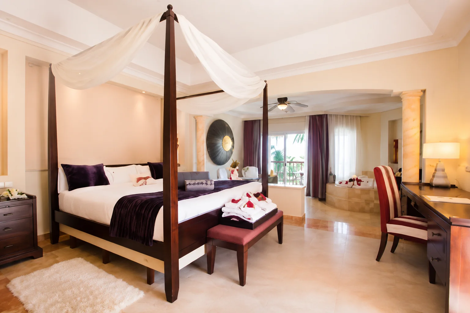 Majestic Elegance Punta Cana luxury suite with four-poster bed and private Jacuzzi