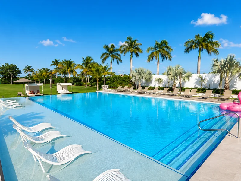 C Hotel Punta Cana tropical swimming pool with palm trees and lounge chairs