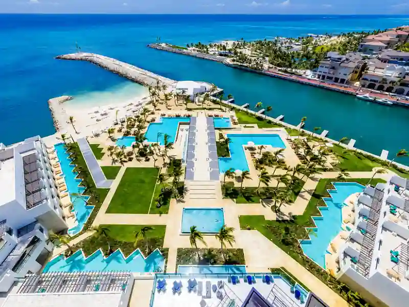 Aerial view of Punta Cana marina resort with swimming pools, tropical gardens and Caribbean Sea