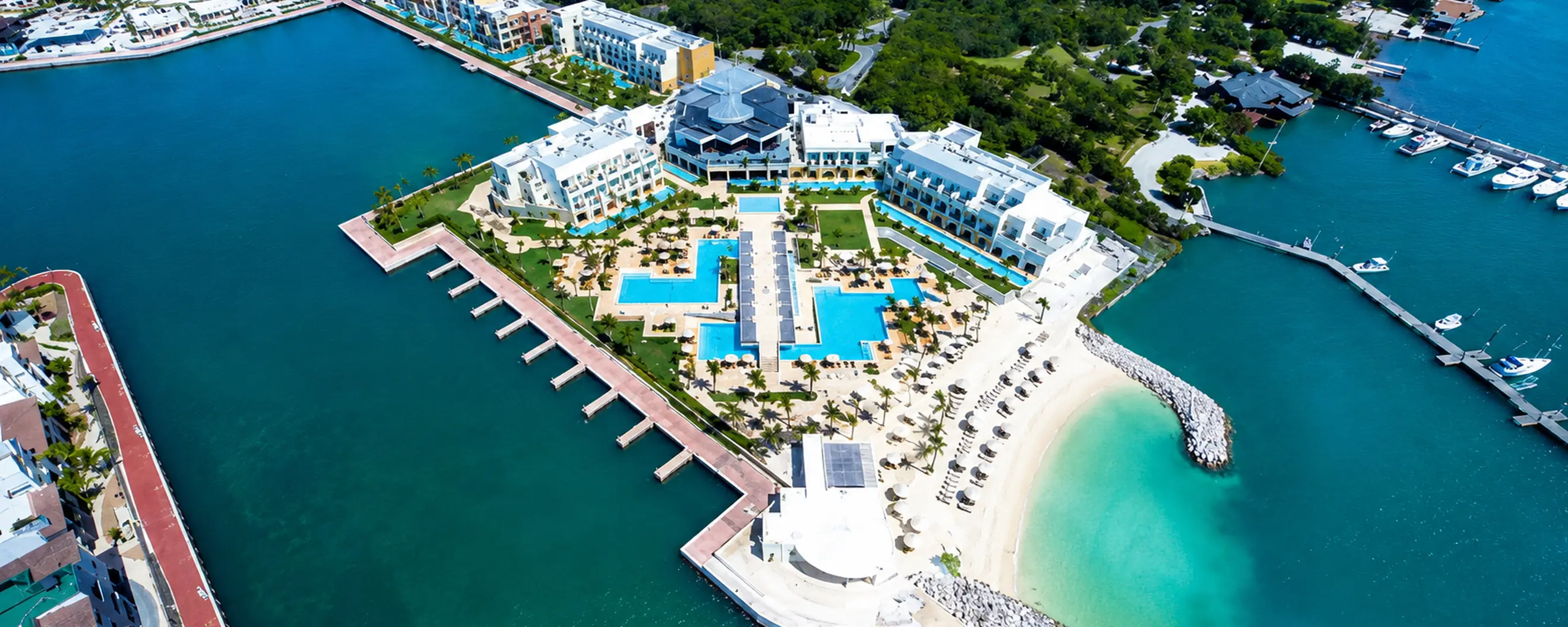 Aerial view of luxury marina resort in Punta Cana with pools and private beach