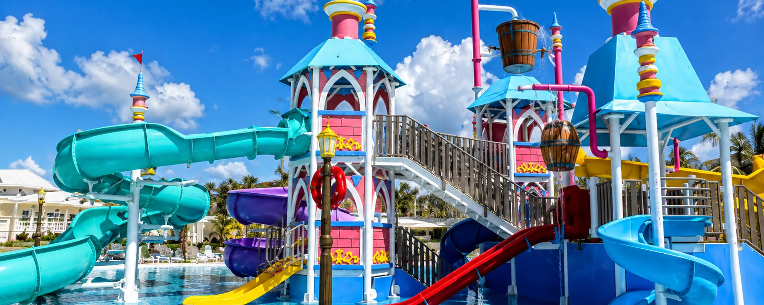 Colorful Punta Cana family resort water park with waterslides and splash pool