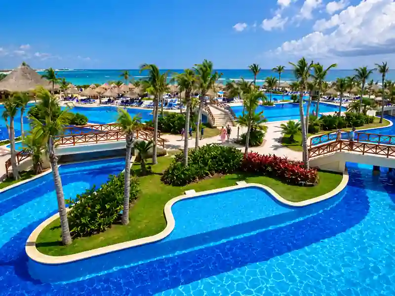 Bahia Principe Grand Aquamarine Punta Cana tropical pool with palm trees and ocean view