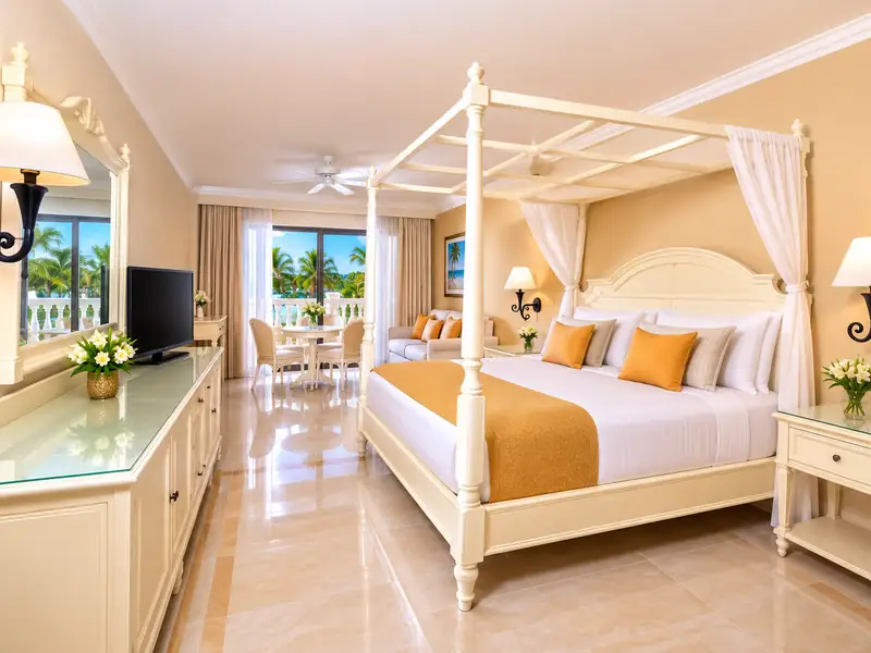 Bahia Principe Grand Aquamarine Punta Cana guest room with four-poster bed and tropical view