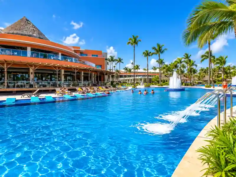 Barceló Bávaro Palace main swimming pool with palm trees and tropical resort in Punta Cana