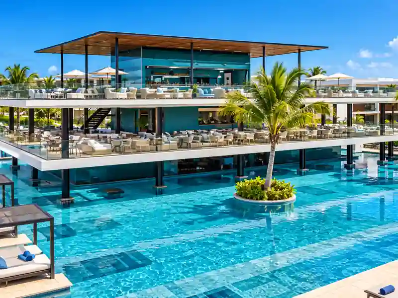 Luxury Punta Cana resort pool with modern restaurant and tropical palm trees