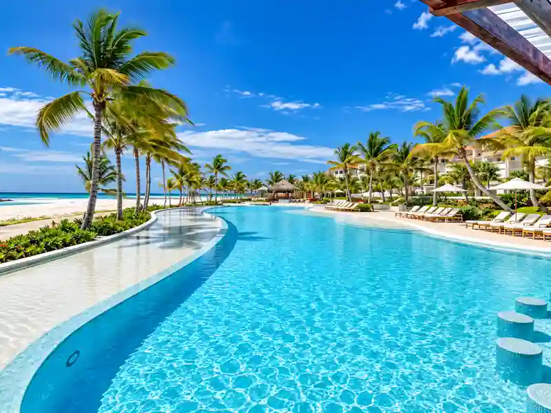 Bahia Principe Ambar beachfront swimming pool with palm trees in Punta Cana