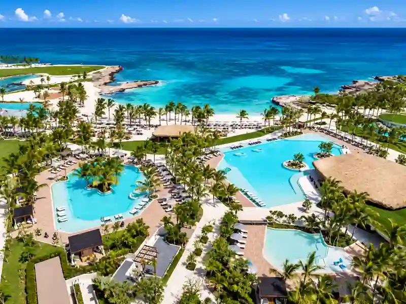 Aerial view of luxury beachfront resort pools and turquoise Caribbean Sea in Punta Cana