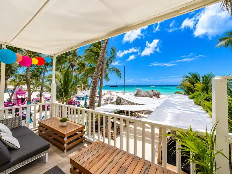 Beachfront balcony with tropical ocean view and palm trees in Punta Cana