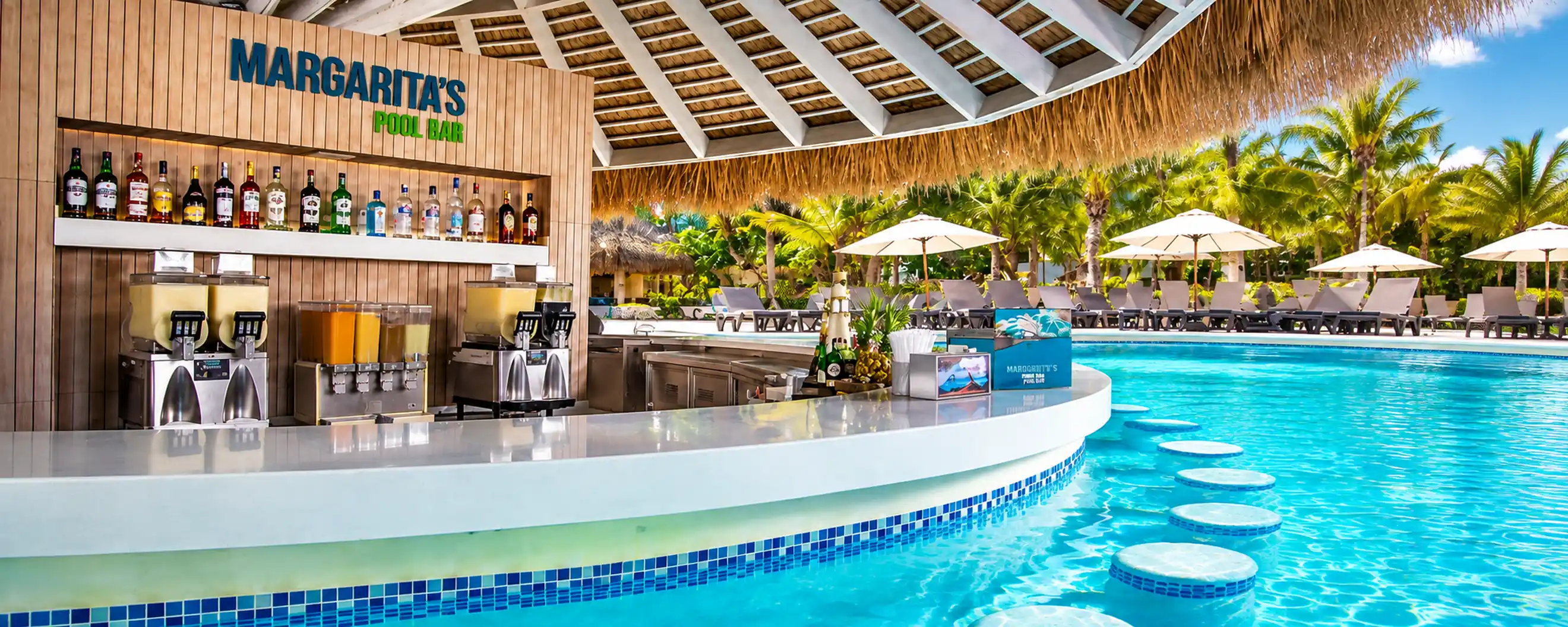 Punta Cana Margaritas swim-up pool bar surrounded by tropical palms and resort pool.