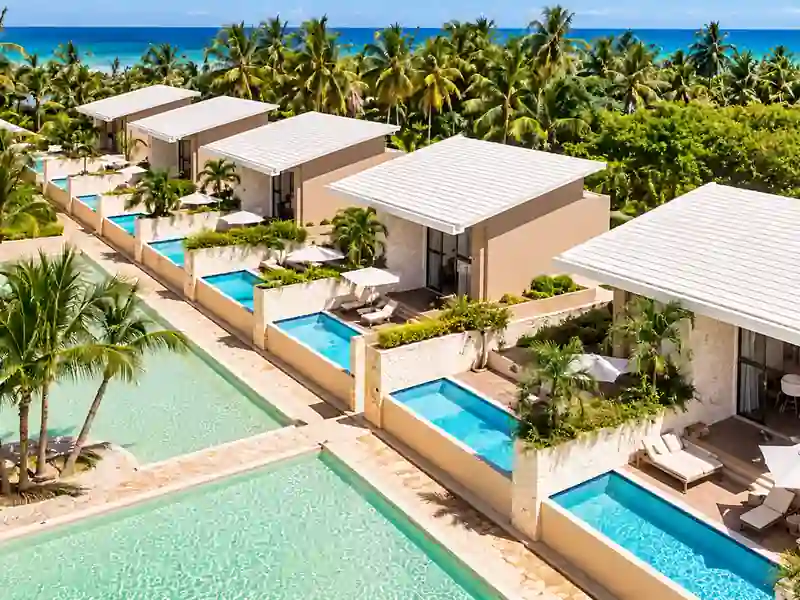 Catalonia Royal Bavaro luxury villas with private pools, tropical palms and Caribbean Sea views.