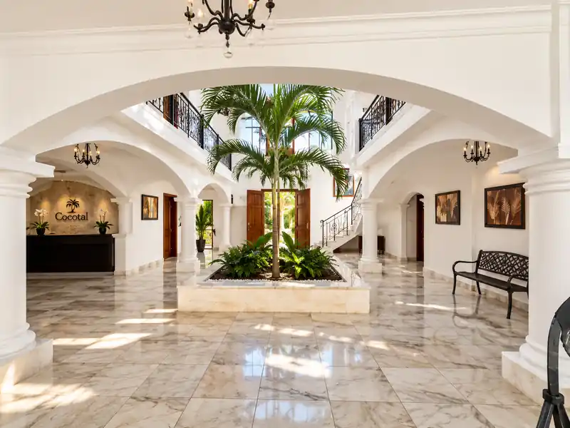 Elegant Cocotal Punta Cana lobby interior with tropical courtyard, marble floors and palm trees