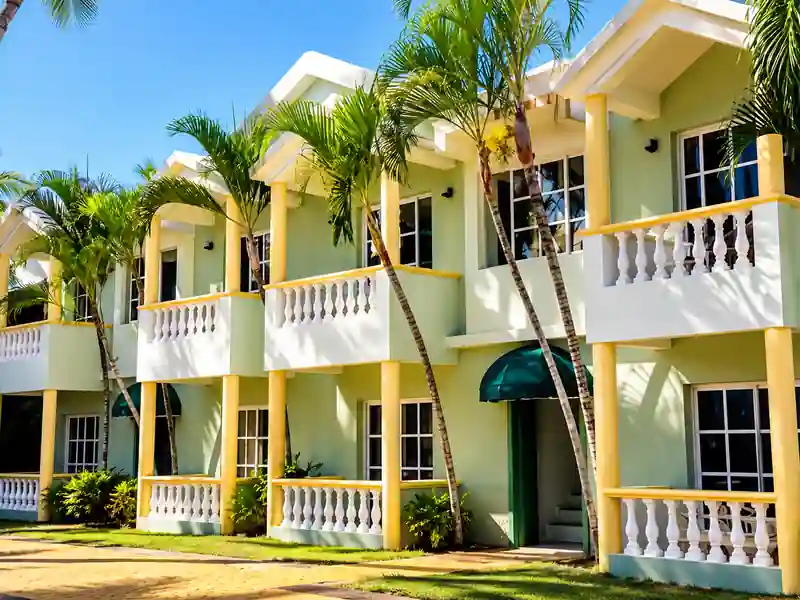 Cortecito Inn Punta Cana tropical hotel exterior with balconies and palm trees