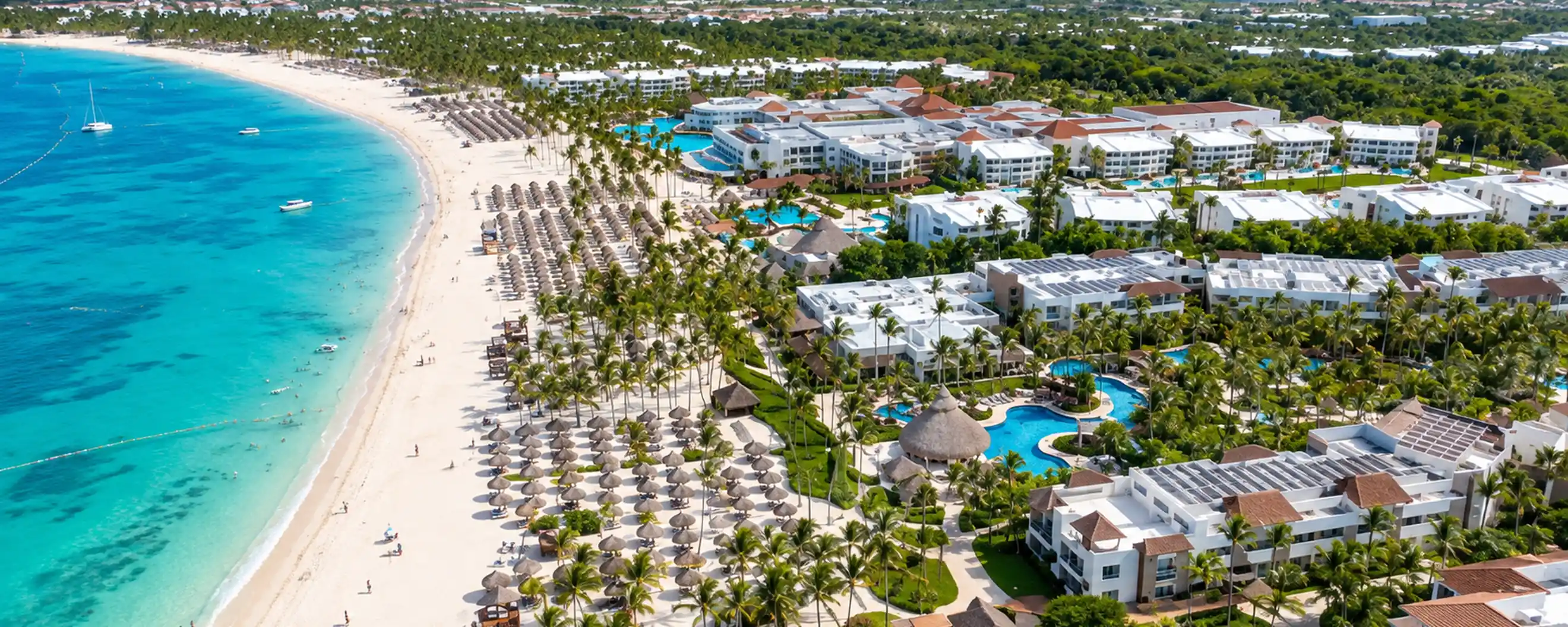 Aerial view of Dreams Cap Cana beachfront resort with turquoise Caribbean water and tropical pools