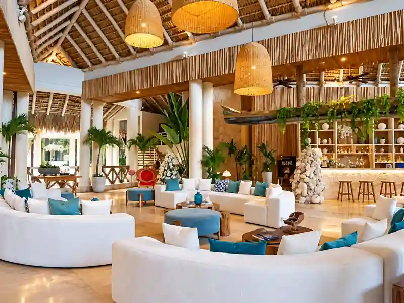 Eden Roc Cap Cana luxury hotel lobby with tropical decor and lounge seating