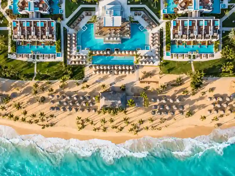 Excellence El Carmen hotel aerial view with beachfront pools and Caribbean ocean