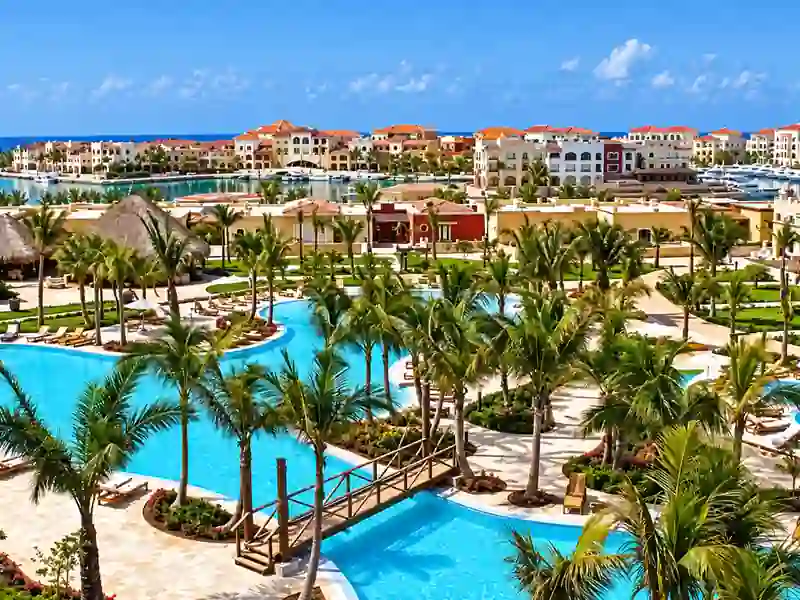 Fishing Lodge Cap Cana resort with tropical pools, palm trees, and marina views