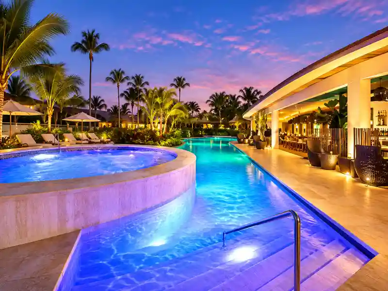 Grand Palladium Palace Resort Spa & Casino illuminated pool and pool bar at sunset in Punta Cana