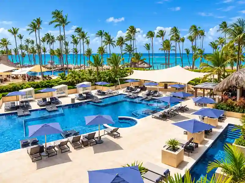 Hideaway at Royalton Punta Cana luxury pool with palm trees and Caribbean ocean view